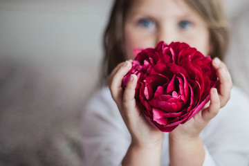 Girl holding a red flower