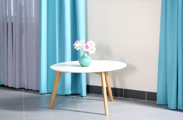 Table with flowers in the room