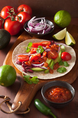 vegan taco with avocado tomato kidney beans and salsa
