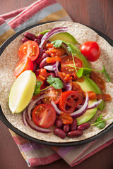 vegan taco with avocado tomato kidney beans and salsa