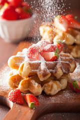 belgian waffles with icing sugar and strawberry