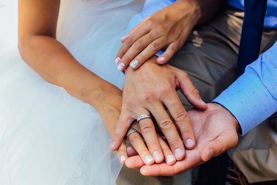 Man's and woman's hands with wedding rings