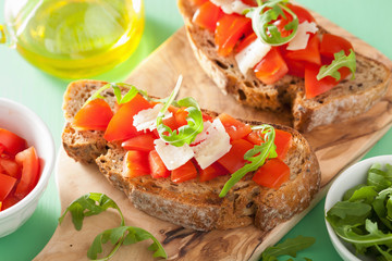 italian bruschetta with tomatoes parmesan arugula