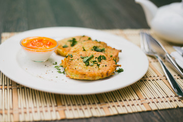 Potato cutlets with sour cream isolated on white 