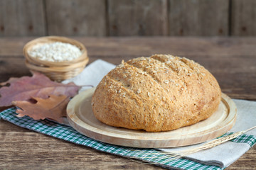 Homemade oatmeal bread with whole wheat flour on the old table