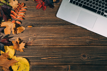 Background with laptop and autumnal leaves