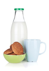 Cup, bottle of milk and bowl with cookies