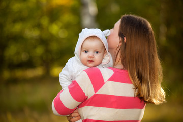 Happy Young Caucasian mother and son outdoors in park 