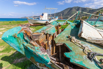Fototapeta na wymiar Derelict Fishing Boats out of sea in afternoon light in Pomos harbor, Cyprus