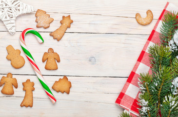 Christmas background with candy cane, gingerbread cookies and sn