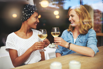 Pretty young women toasting each other