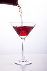 Red wine being poured into glass 