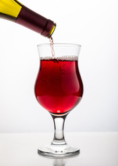 Red wine being poured into glass 