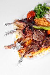 Grilled Lamb Ribs with Herbs and Pide Served Over White Plate