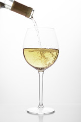 White wine pouring in a glass