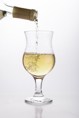 White wine pouring in a glass