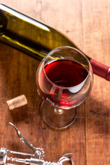 Red wine against wooden background