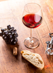 Red wine against wooden background