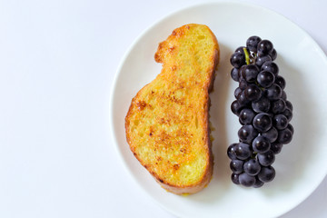 French toast and ripe grapes on a plate for breakfast