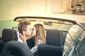 Couple kissing in a car