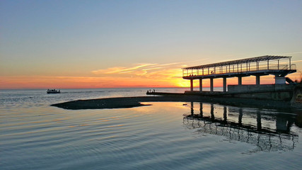 Fototapeta premium The river and the sea at sunset, seaside Sochi, Russia