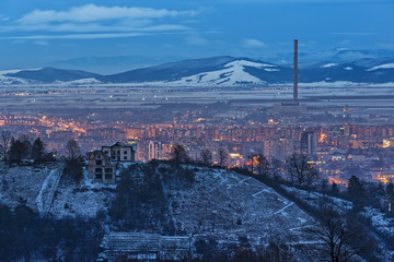 Picturesque aerial winter cityscape of downtown residential district of Brasov city at dusk, Romania.