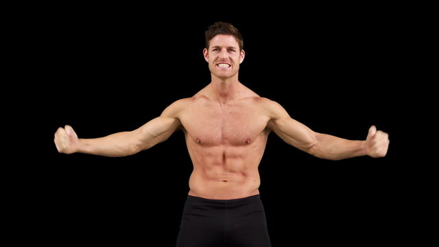 Muscular man flexing muscles in front of camera 