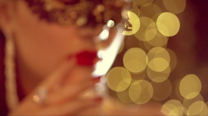 Sexy woman wearing venetian masquerade mask at party
