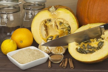 Domestic production pumpkin marmalade. Sweet children's menu. Preserving domestic products. Processing pumpkins, autumn harvest time. Pumpkin jam in glass jar with ingredients.
