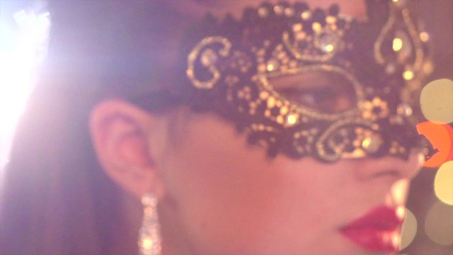 Sexy woman wearing venetian masquerade mask at party