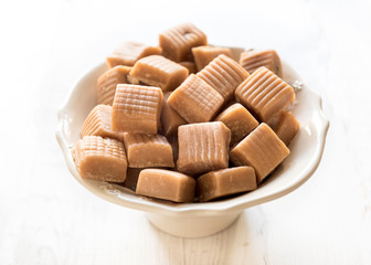 Sweet caramel bonbons in the bowl,selective focus