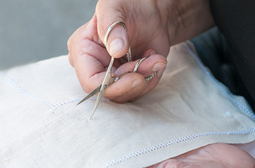 Senior Woman holding scisor and knitting