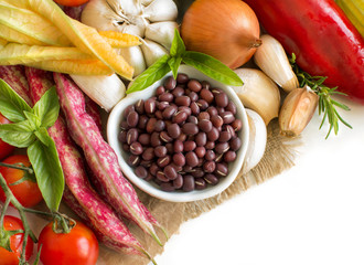 Raw azuki beans in a bowl and fresh vegetables