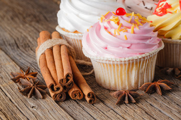 Colored cupcake on rustic background