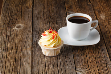 Colored cupcake on rustic background