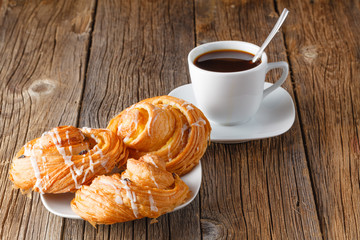 Fresh pastry rolls and coffee cup