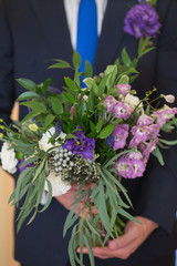 Wwedding bouquet in groom hand