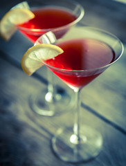 Two cosmopolitan cocktails on the wooden background