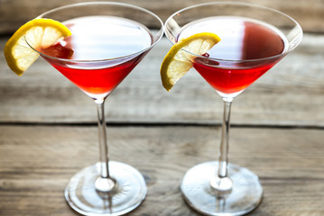Two cosmopolitan cocktails on the wooden background