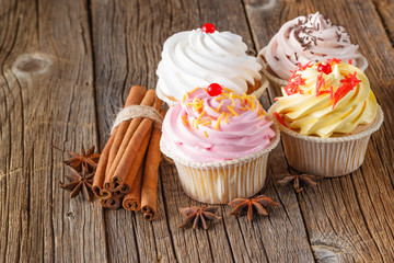 Colored cupcake on rustic background