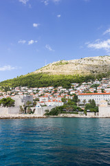 View of buildings on the hillside and Mount Srd from the sea in Croatia. Copy space.