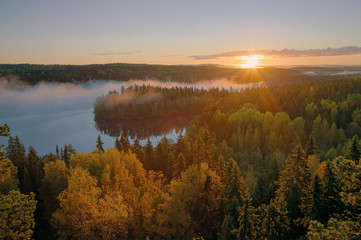 Fototapeta na wymiar Foggy autumn sunrise one early morning at Aulanko nature park in Finland. HDR image