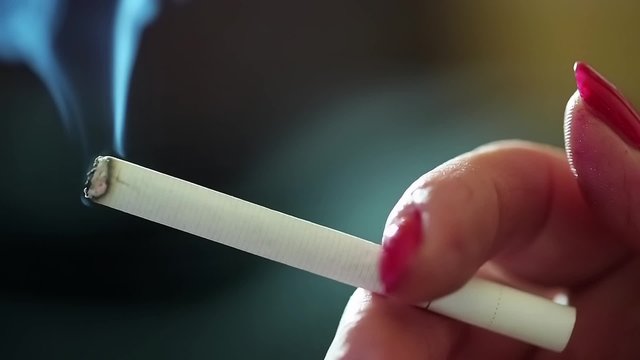 A senior woman hand with cigarette, female smoker