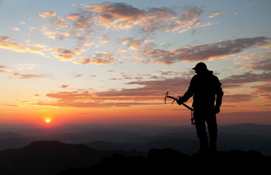 view of man on mountains with ice axe in hand