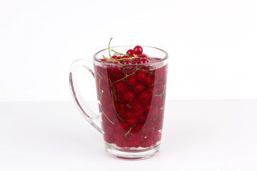 red currants in glass, isolated on white background 