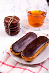 Tea, eclairs and cinnamon on a table