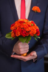 wedding bouquet in groom hand