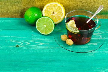 Tea sugar a lemon and a lime on a table