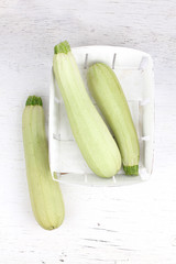 Fresh sliced marrow vegetable in basket. Isolated on white background 