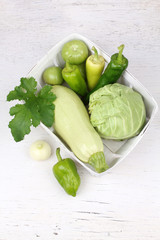 fresh green vegetables in basket isolated on white 